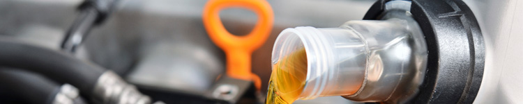 oil being poured into a car engine 