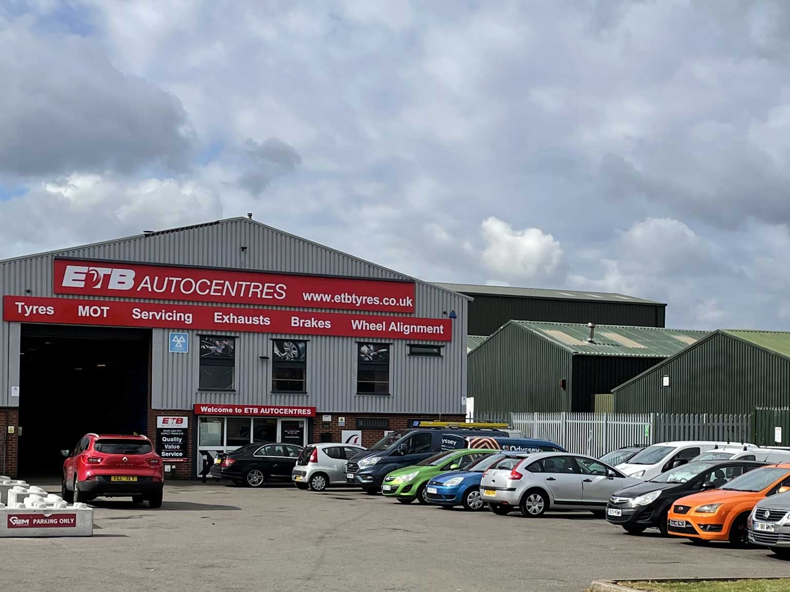 car park with cars outside of building of ETB Tyres in Tamworth